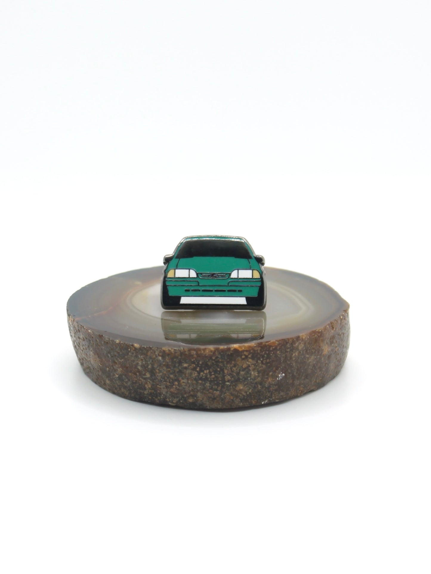 Vintage American muscle car design lapel pin. This Ford Mustang Foxbody decorative pin is offered in Ford's original paint code Bright Calypso Green. Available for a fan or as a gift for your boyfriend, girlfriend, wife, husband, etc.