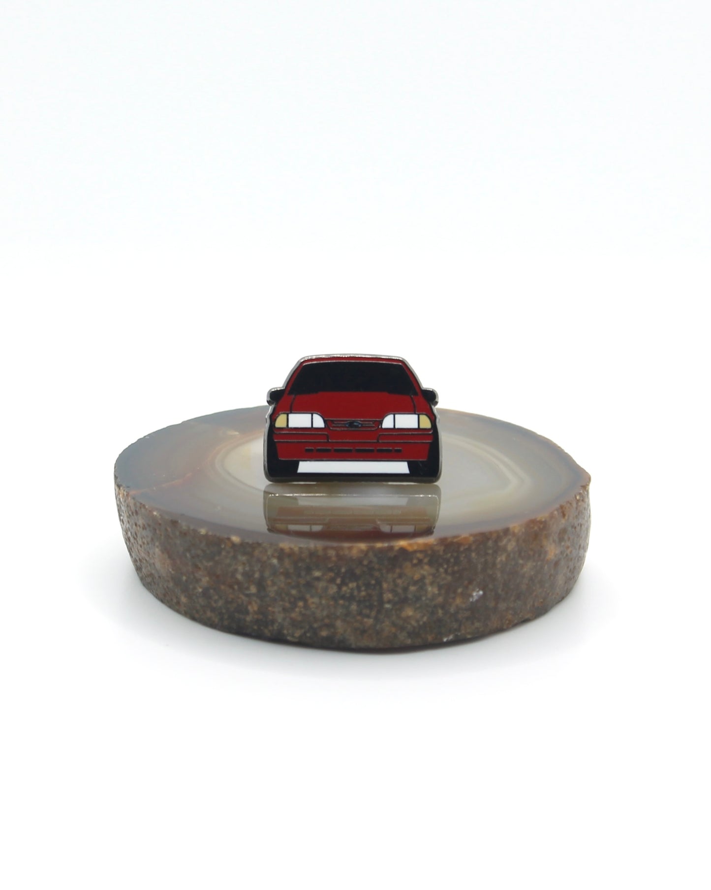 Vintage American muscle car design lapel pin. This Ford Mustang Foxbody decorative pin is offered in Ford's original paint code Scarlet Red. Available for a fan or as a gift for your boyfriend, girlfriend, wife, husband, etc.