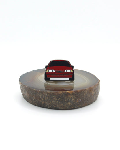 Vintage American muscle car design lapel pin. This Ford Mustang Foxbody decorative pin is offered in Ford's original paint code Scarlet Red. Available for a fan or as a gift for your boyfriend, girlfriend, wife, husband, etc.